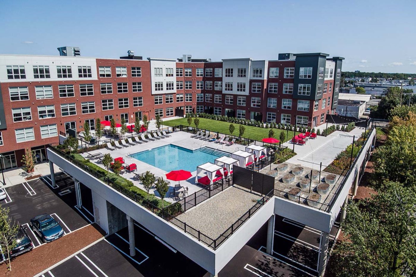 Aerial view of the courtyard, pool deck and bocce court above covered parking