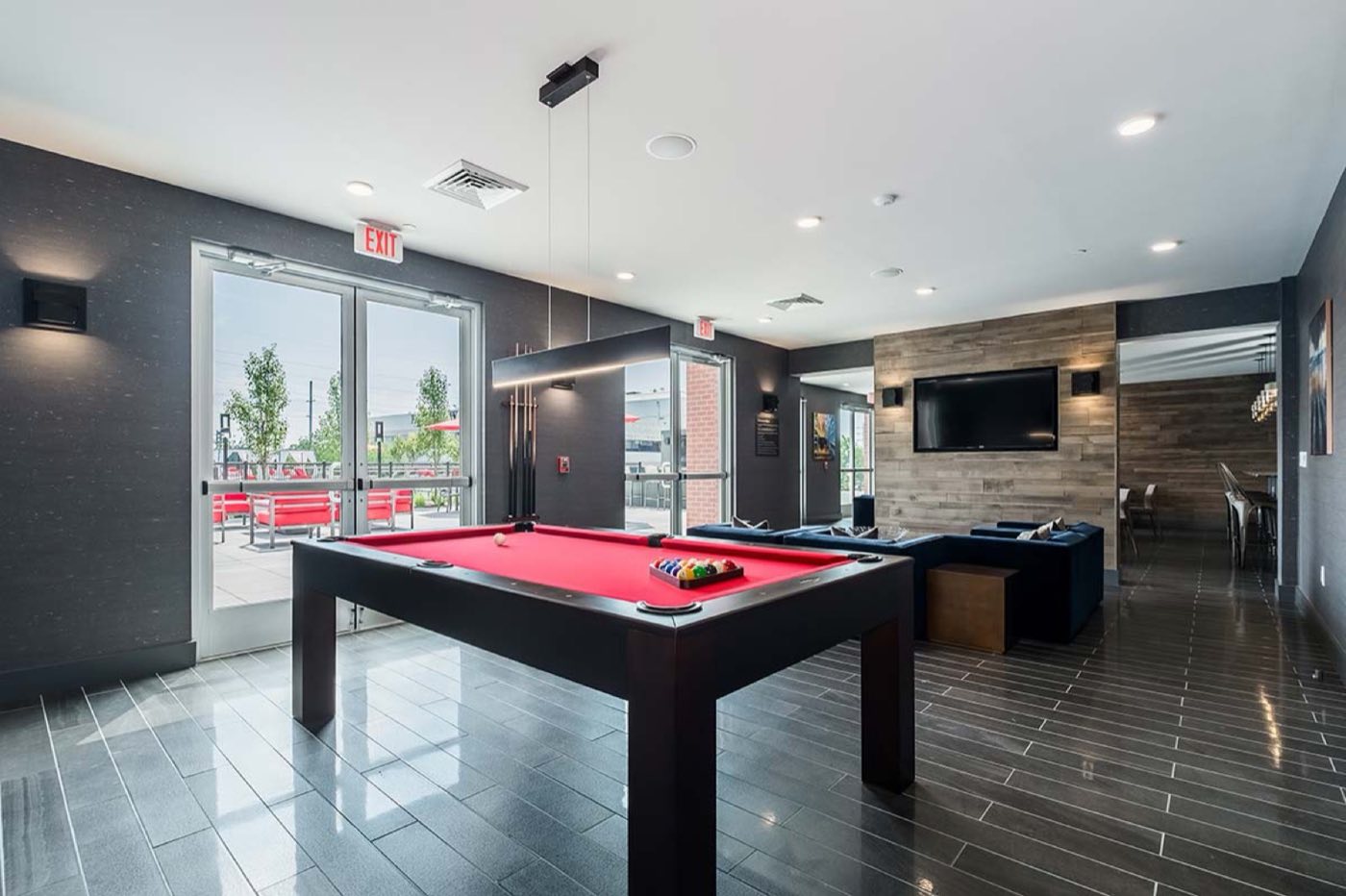 The Trademark Fairfield games room, with a pool table and a wall of glass onto the deck
