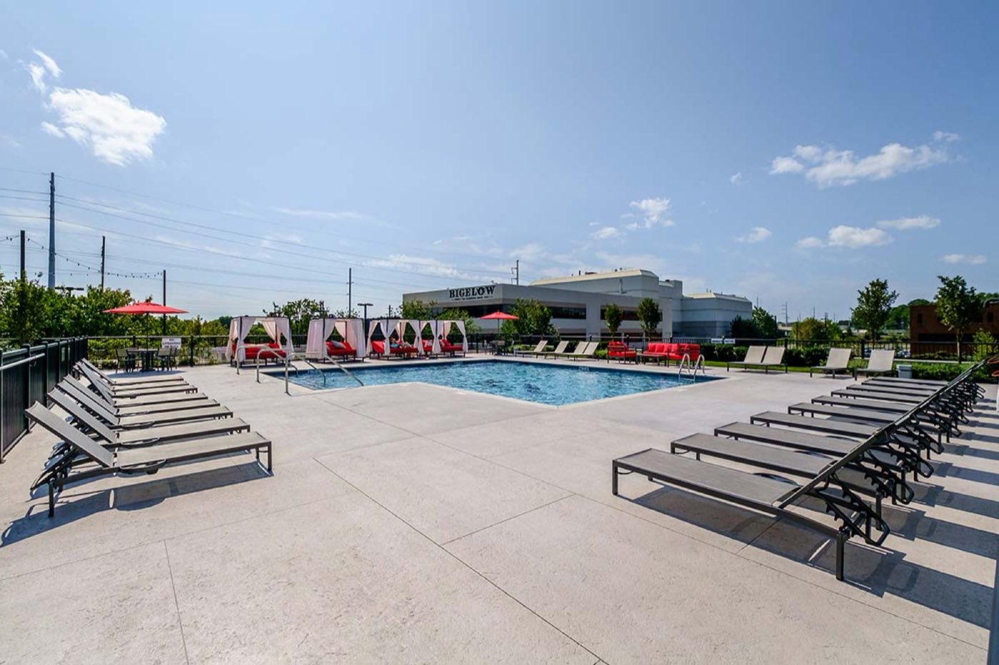 The resort-style pool with loungers and cabanas
